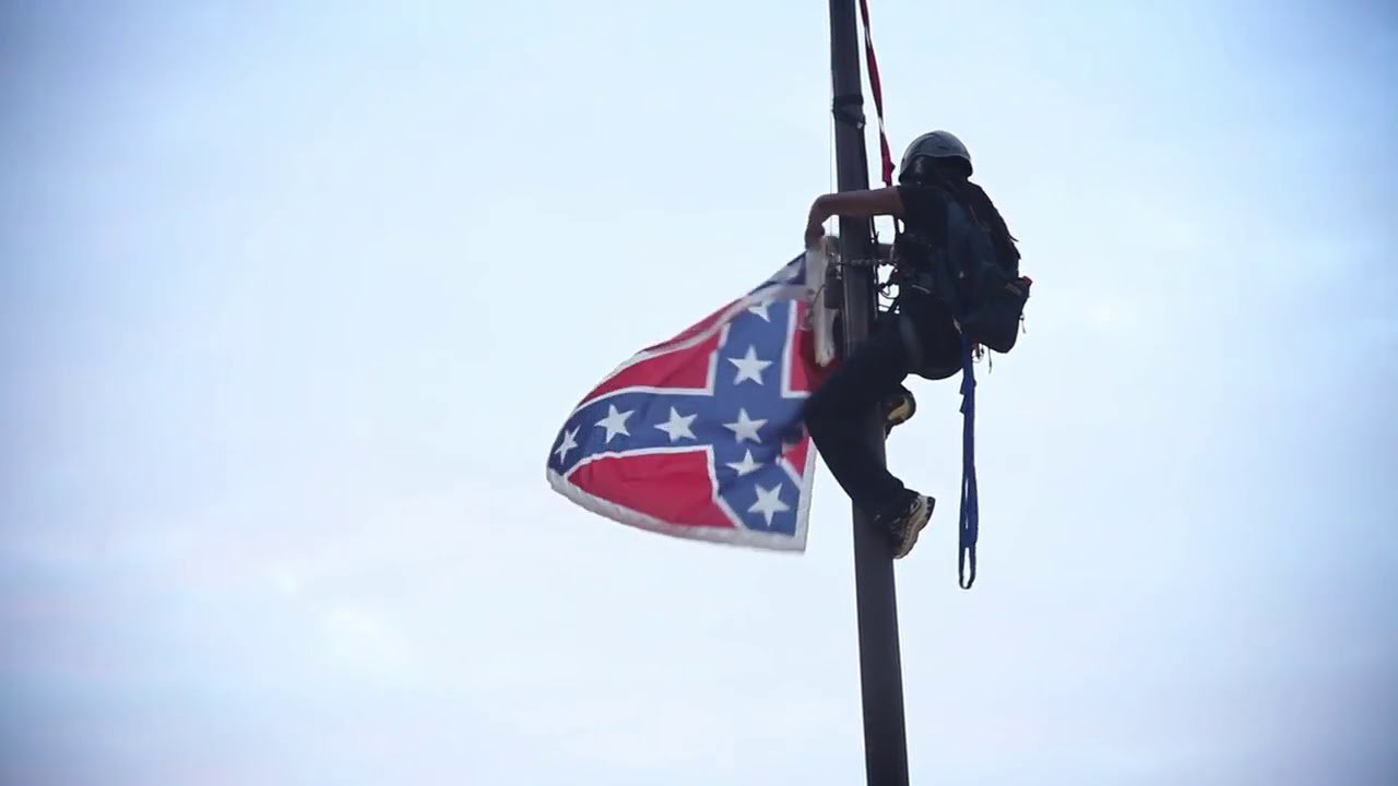 Woman climbs pole, removes Confederate flag